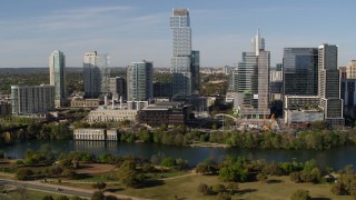 DX0002_109_006 - 5.7K aerial stock footage modern skyscraper on the opposite side of Lady Bird Lake, Downtown Austin, Texas