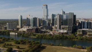 DX0002_109_007 - 5.7K aerial stock footage modern skyscraper on the other side of Lady Bird Lake, Downtown Austin, Texas