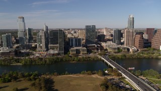 DX0002_109_015 - 5.7K aerial stock footage of flying by the city's waterfront skyline on the other side of Lady Bird Lake, Downtown Austin, Texas