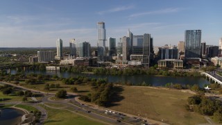 DX0002_109_018 - 5.7K aerial stock footage of a view of tall skyscrapers in the city's waterfront skyline across Lady Bird Lake, Downtown Austin, Texas