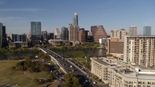 DX0002_109_020 - 5.7K aerial stock footage ascend for view of the city's waterfront skyline, seen from apartment building and hotel, Downtown Austin, Texas