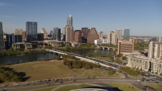 DX0002_109_022 - 5.7K aerial stock footage a view of the city's waterfront skyline and First Street Bridge over Lady Bird Lake, Downtown Austin, Texas