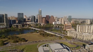 DX0002_109_023 - 5.7K aerial stock footage a reverse view of the city's waterfront skyline and First Street Bridge over Lady Bird Lake, Downtown Austin, Texas
