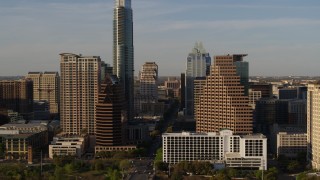 DX0002_109_034 - 5.7K aerial stock footage reveal the state capitol while flying between skyscrapers in Downtown Austin, Texas