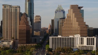 DX0002_109_038 - 5.7K aerial stock footage of the state capitol building seen between skyscrapers in Downtown Austin, Texas