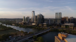 DX0002_110_001 - 5.7K aerial stock footage the city's waterfront skyline and Lady Bird Lake at sunset in Downtown Austin, Texas