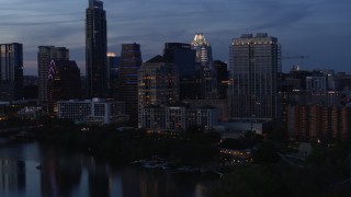 DX0002_110_040 - 5.7K aerial stock footage approach San Jacinto Center beside Lady Bird Lake at twilight in Downtown Austin, Texas