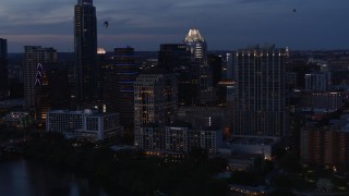 DX0002_110_041 - 5.7K aerial stock footage fly away from, then approach, San Jacinto Center at twilight in Downtown Austin, Texas