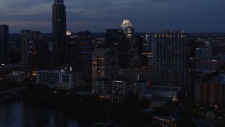 DX0002_110_042 - 5.7K aerial stock footage fly away from San Jacinto Center at twilight in Downtown Austin, Texas