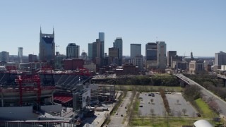 DX0002_112_006 - 5.7K aerial stock footage of the city's skyline seen while passing football stadium in Downtown Nashville, Tennessee