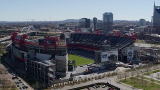 DX0002_112_010 - 5.7K aerial stock footage of orbiting the football stadium with view of the field in Nashville, Tennessee
