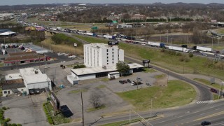 DX0002_112_012 - 5.7K aerial stock footage of orbiting a hotel by the freeway in Nashville, Tennessee