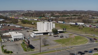 DX0002_112_013 - 5.7K aerial stock footage of circling a hotel by the freeway in Nashville, Tennessee