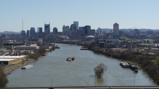DX0002_112_020 - 5.7K aerial stock footage a wide view of the city's skyline a barge sails the river in Downtown Nashville, Tennessee