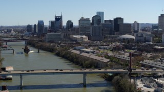 DX0002_113_013 - 5.7K aerial stock footage flyby bridge over the river, focus on city's skyline Downtown Nashville, Tennessee