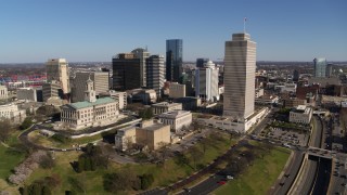 DX0002_114_003 - 5.7K aerial stock footage wide orbit of the Tennessee State Capitol, Tennessee Tower near skyscrapers in Downtown Nashville, Tennessee