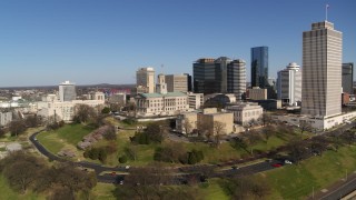DX0002_114_010 - 5.7K aerial stock footage orbit Tennessee State Capitol near tall skyscrapers in Downtown Nashville, Tennessee