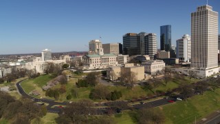 DX0002_114_011 - 5.7K aerial stock footage circle around Tennessee State Capitol near tall skyscrapers in Downtown Nashville, Tennessee