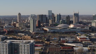 DX0002_114_014 - 5.7K aerial stock footage ascend for view of convention center and skyline in Downtown Nashville, Tennessee