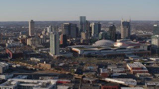 DX0002_114_015 - 5.7K aerial stock footage stationary and passing view of convention center and skyline in Downtown Nashville, Tennessee