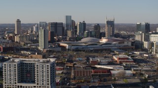 DX0002_114_018 - 5.7K aerial stock footage of a reverse view of the convention center and skyline in Downtown Nashville, Tennessee