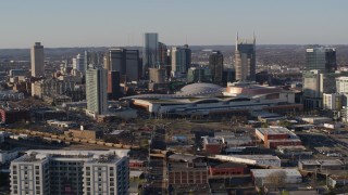 DX0002_114_021 - 5.7K aerial stock footage approach the city skyline behind the convention center in Downtown Nashville, Tennessee
