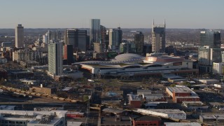 DX0002_114_026 - 5.7K aerial stock footage of the city skyline behind the convention center during ascent in Downtown Nashville, Tennessee