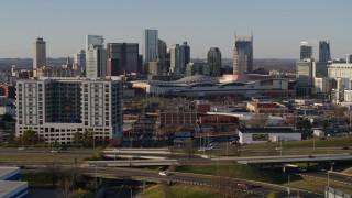 DX0002_114_027 - 5.7K aerial stock footage of the city skyline and convention center, reveal I-65 in Downtown Nashville, Tennessee