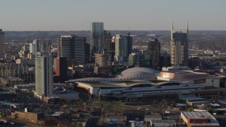 DX0002_114_029 - 5.7K aerial stock footage of slowly flying away from the city skyline and the convention center in Downtown Nashville, Tennessee