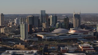 DX0002_114_030 - 5.7K aerial stock footage of approach and orbit the convention center and city skyline in Downtown Nashville, Tennessee