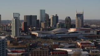 DX0002_114_034 - 5.7K aerial stock footage of passing the city skyline and the convention center in Downtown Nashville, Tennessee