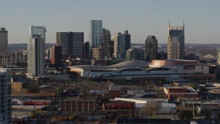 DX0002_114_035 - 5.7K aerial stock footage flying past city's tall skyline by the convention center in Downtown Nashville, Tennessee