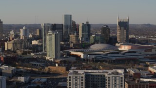 DX0002_114_040 - 5.7K aerial stock footage reverse view of city's tall skyline beside Nashville Music City Center in Downtown Nashville, Tennessee