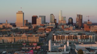 DX0002_115_004 - 5.7K aerial stock footage of a reverse view of the city's skyline at sunset in Downtown Nashville, Tennessee