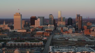 DX0002_115_006 - 5.7K aerial stock footage of a reverse view of the city's skyline at sunset during ascent in Downtown Nashville, Tennessee