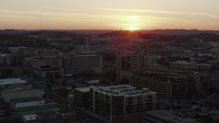 DX0002_115_013 - 5.7K aerial stock footage descend and orbit hospital with view of setting sun, Nashville, Tennessee