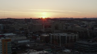 DX0002_115_014 - 5.7K aerial stock footage slowly descend and orbit hospital with view of setting sun, Nashville, Tennessee