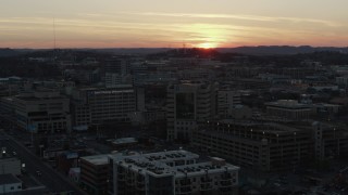 DX0002_115_018 - 5.7K aerial stock footage a hospital complex with view of setting sun, seen during descent and orbit, Nashville, Tennessee