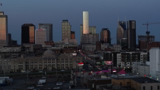 DX0002_115_022 - 5.7K aerial stock footage descend and flyby Church Street with view of city's skyline at twilight in Downtown Nashville, Tennessee
