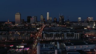 DX0002_115_035 - 5.7K aerial stock footage ascend near Church Street to approach city skyline at twilight, Downtown Nashville, Tennessee