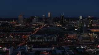 DX0002_115_037 - 5.7K aerial stock footage flyby Church Street and city skyline at twilight, reveal high-rise construction, Downtown Nashville, Tennessee