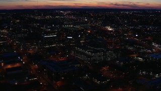 DX0002_115_047 - 5.7K aerial stock footage slowly orbit and approach a hospital complex at twilight, Nashville, Tennessee