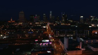 DX0002_115_053 - 5.7K aerial stock footage the city skyline at night while passing flashing lights on Church Street, Downtown Nashville, Tennessee