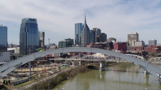 DX0002_116_006 - 5.7K aerial stock footage fly over a bridge spanning the river to approach AT&T Building in Downtown Nashville, Tennessee
