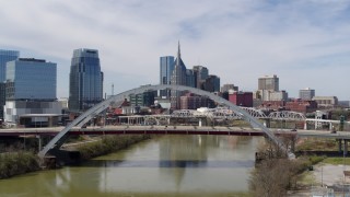 DX0002_116_009 - 5.7K aerial stock footage stationary view of bridge and skyscrapers in Downtown Nashville, Tennessee