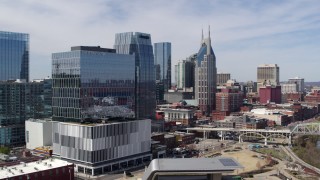 DX0002_116_016 - 5.7K aerial stock footage of descend near an office high-rise with view of AT&T Building in Downtown Nashville, Tennessee