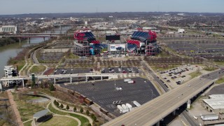DX0002_116_018 - 5.7K aerial stock footage reverse view of Nissan Stadium seen from a bridge in Nashville, Tennessee