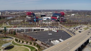 DX0002_116_019 - 5.7K aerial stock footage of Nissan Stadium while descending near a bridge in Nashville, Tennessee