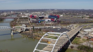 DX0002_116_021 - 5.7K aerial stock footage of a wide orbit of Nissan Stadium, seen from near a bridge in Nashville, Tennessee