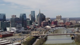 DX0002_116_038 - 5.7K aerial stock footage of the city's tall skyscrapers and a bridge on the Cumberland River in Downtown Nashville, Tennessee